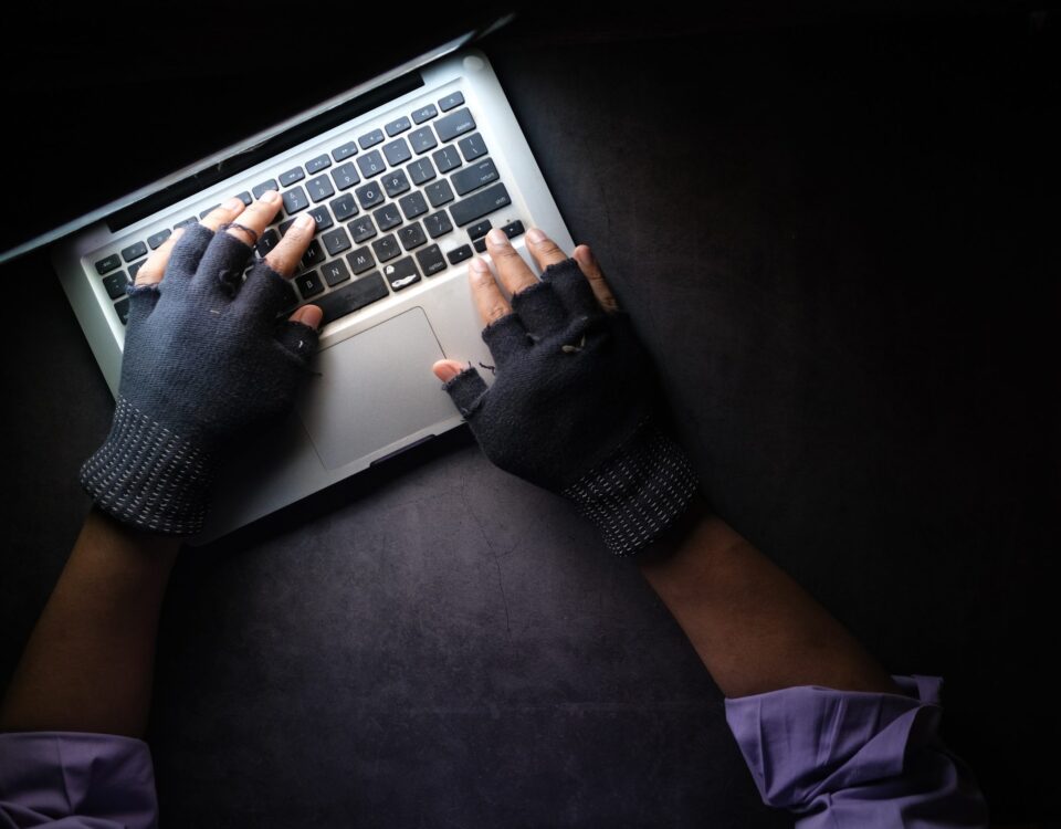 person in black long sleeve shirt using macbook pro