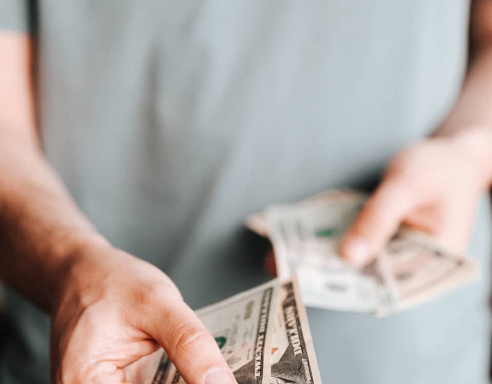 Free Crop man paying with American dollars Stock Photo